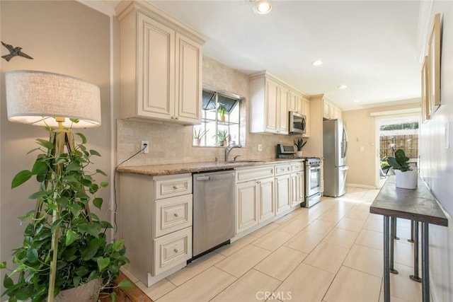 417 N Lamer St, Burbank, CA 91506 - kitchen with appliances with stainless steel finishes, cream cabinets, backsplash, light stone countertops, and recessed lighting