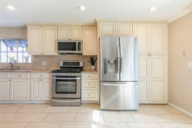 417 N Lamer St, Burbank, CA 91506 - kitchen featuring appliances with stainless steel finishes, cream cabinets, backsplash, light stone countertops, and crown molding
