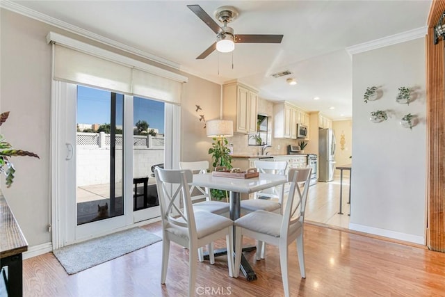 417 N Lamer St, Burbank, CA 91506 - dining space with healthy amount of natural light, light wood-style floors, ceiling fan, and crown molding