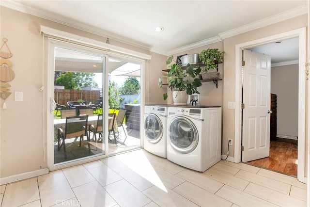 417 N Lamer St, Burbank, CA 91506 - laundry room with washing machine and dryer, ornamental molding, and light wood-style flooring