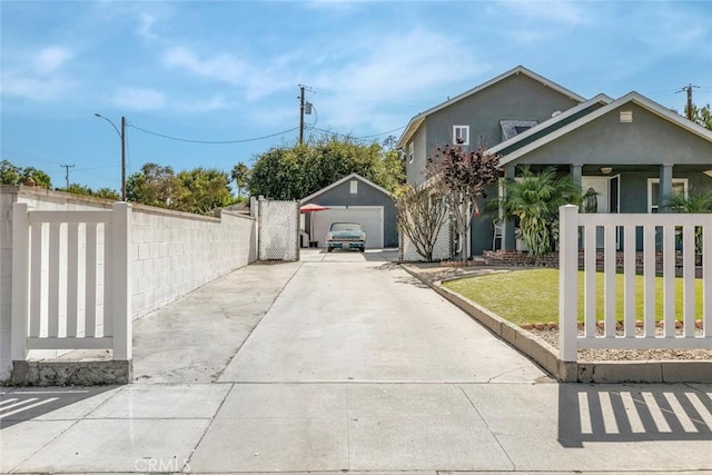 417 N Lamer St, Burbank, CA 91506 - view of side of property featuring a detached garage, driveway, an outbuilding, and stucco siding