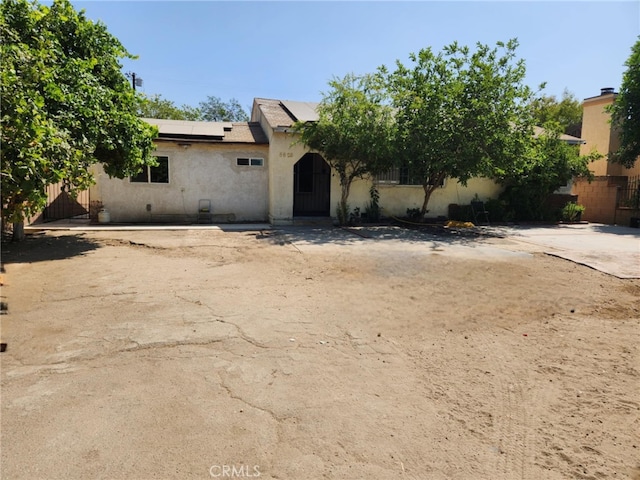 8626 Laurel Canyon Blvd, Sun Valley, CA 91352 - obstructed view of property with solar panels and stucco siding