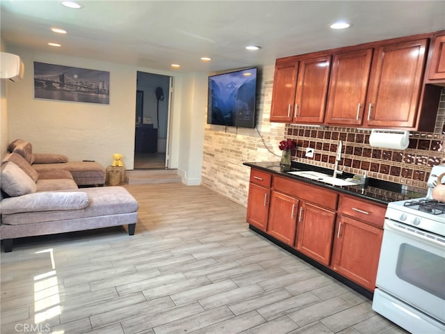 8626 Laurel Canyon Blvd, Sun Valley, CA 91352 - kitchen featuring white range with gas cooktop, decorative backsplash, recessed lighting, open floor plan, and light wood-style flooring