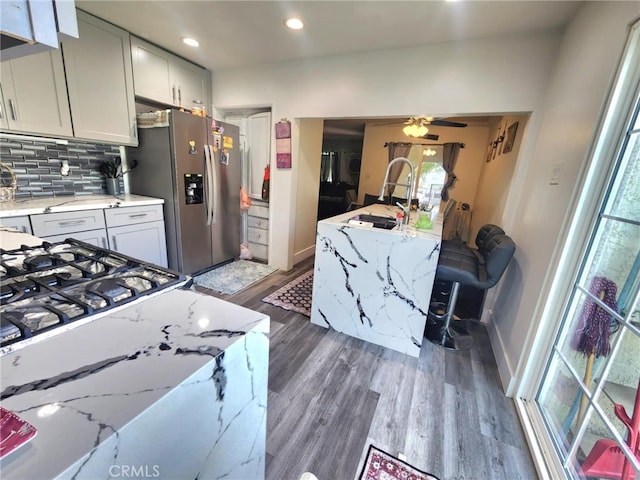 8626 Laurel Canyon Blvd, Sun Valley, CA 91352 - kitchen featuring stainless steel fridge, dark wood-type flooring, decorative backsplash, light stone countertops, and recessed lighting
