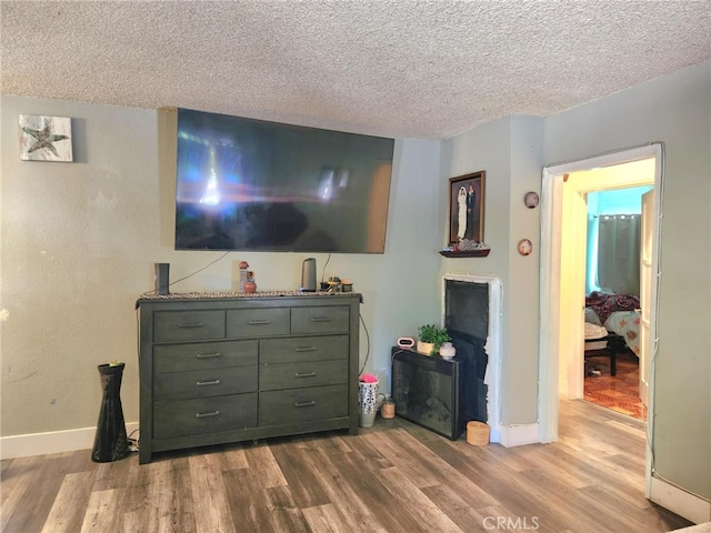 8626 Laurel Canyon Blvd, Sun Valley, CA 91352 - living area featuring wood finished floors and a textured ceiling