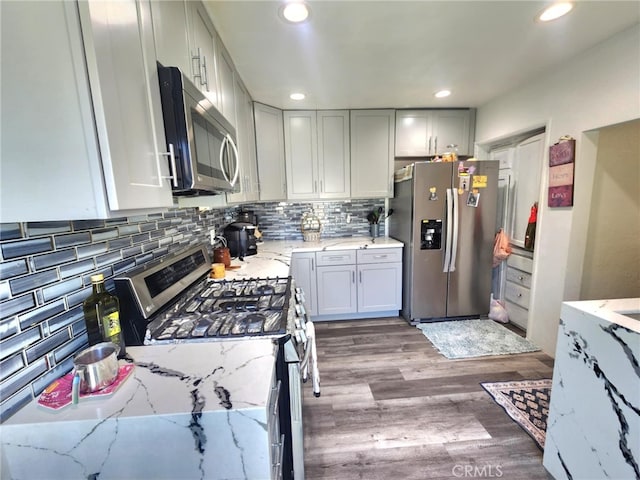 8626 Laurel Canyon Blvd, Sun Valley, CA 91352 - kitchen featuring stainless steel appliances, wood finished floors, light stone counters, tasteful backsplash, and recessed lighting