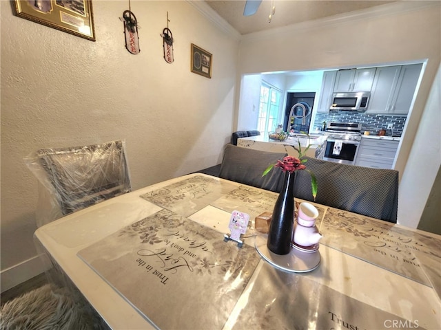 8626 Laurel Canyon Blvd, Sun Valley, CA 91352 - dining space with ornamental molding, ceiling fan, and a textured wall