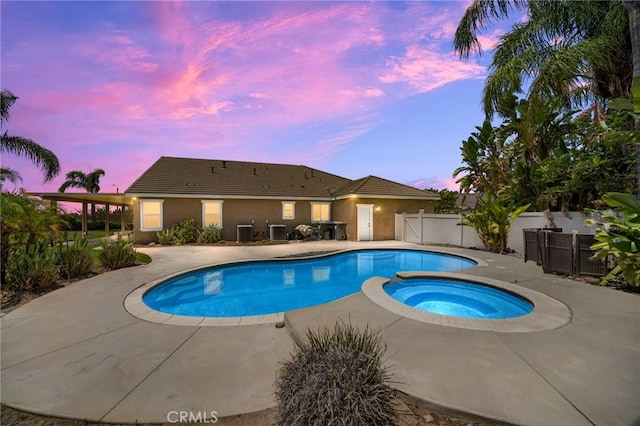 1909 Crystal Cove Ct, Redlands, CA 92374 - pool at dusk featuring a patio and an in-ground hot tub