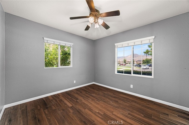 1909 Crystal Cove Ct, Redlands, CA 92374 - empty room with healthy amount of natural light, dark wood-style floors, and ceiling fan
