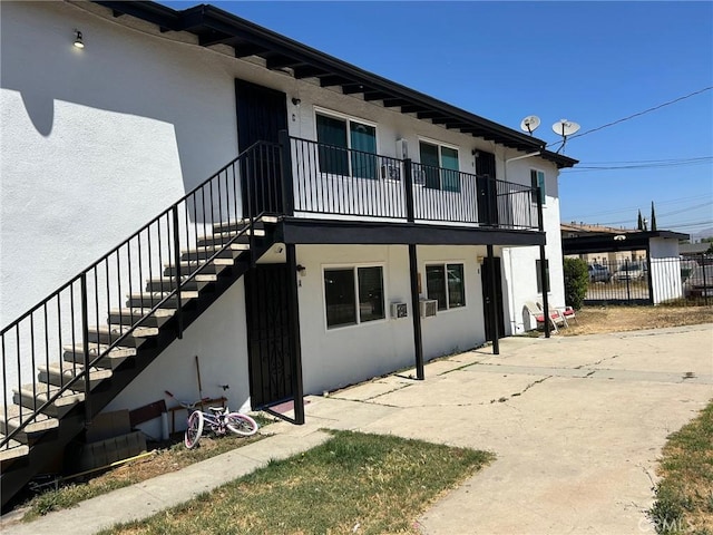 24188 Clover Ave, Moreno Valley, CA 92551 - rear view of house with stucco siding and stairs