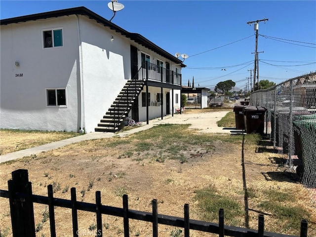 24188 Clover Ave, Moreno Valley, CA 92551 - view of side of property with stucco siding and stairs