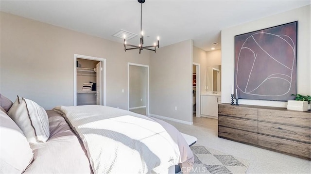 7599 Taylor Ave, Hesperia, CA 92345 - bedroom with a chandelier, light carpet, a spacious closet, and a closet