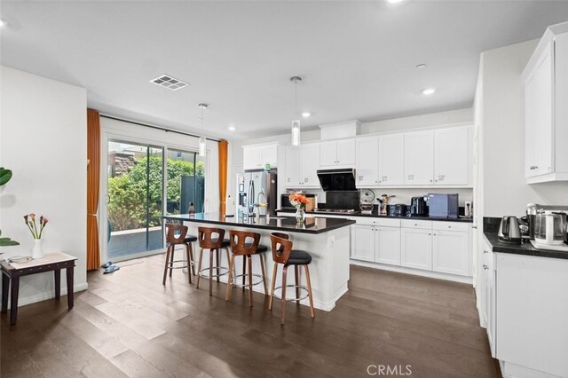 7524 Cessna St, Chino, CA 91708 - kitchen with dark countertops, recessed lighting, white cabinetry, and dark wood-style flooring