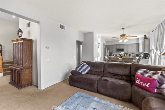32110 Camino Herencia, Temecula, CA 92592 - living area with light carpet, a ceiling fan, and stairs