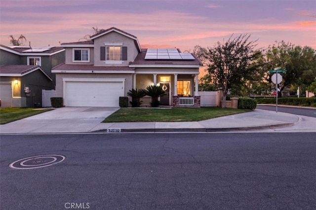 32110 Camino Herencia, Temecula, CA 92592 - traditional home with concrete driveway, roof mounted solar panels, a garage, stucco siding, and covered porch