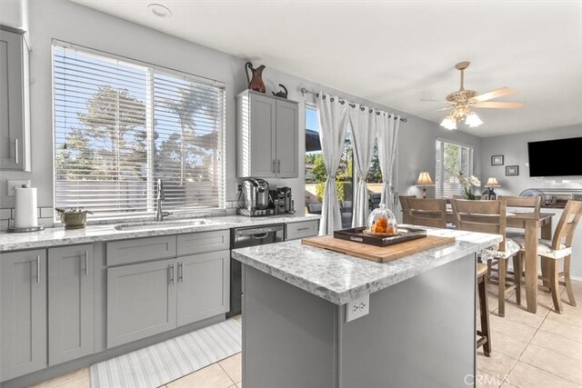 32110 Camino Herencia, Temecula, CA 92592 - kitchen with gray cabinetry, dishwashing machine, light tile patterned floors, and a kitchen island