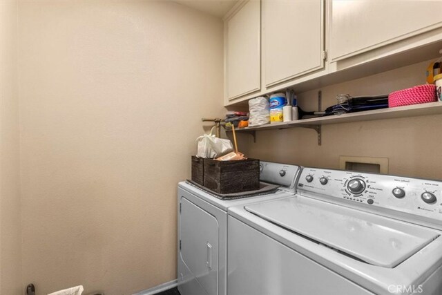 32110 Camino Herencia, Temecula, CA 92592 - laundry room featuring separate washer and dryer and cabinet space