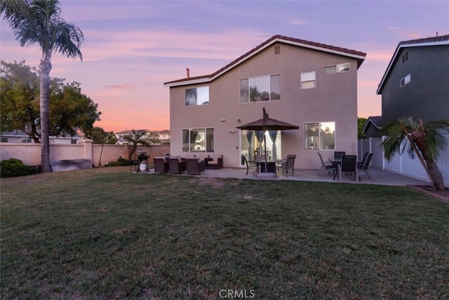 32110 Camino Herencia, Temecula, CA 92592 - back of property at dusk with outdoor lounge area, stucco siding, a fenced backyard, and a patio