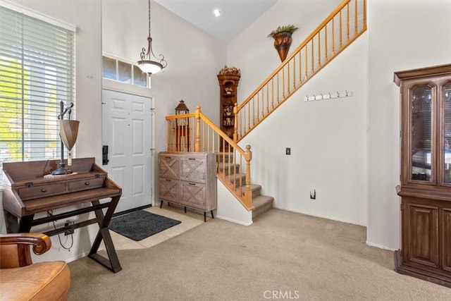 32110 Camino Herencia, Temecula, CA 92592 - entrance foyer with light carpet, stairs, and high vaulted ceiling