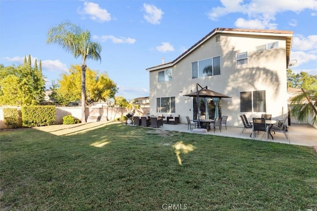 32110 Camino Herencia, Temecula, CA 92592 - rear view of house featuring stucco siding, a patio area, and an outdoor living space