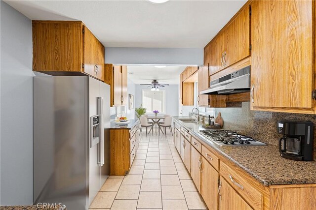 11244 Broadmead St, South El Monte, CA 91733 - kitchen with appliances with stainless steel finishes, under cabinet range hood, light tile patterned flooring, ceiling fan, and tasteful backsplash