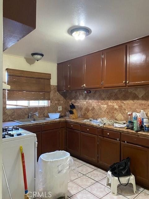 1618 W Burnett, Long Beach, CA 90810 - kitchen featuring white range with gas stovetop, light tile patterned floors, backsplash, and range hood