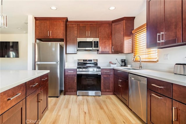 239 W Hillcrest Blvd, Inglewood, CA 90301 - kitchen featuring stainless steel appliances, light wood-style floors, light countertops, recessed lighting, and pendant lighting