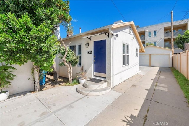 239 W Hillcrest Blvd, Inglewood, CA 90301 - view of front facade with stucco siding, a detached garage, and an outdoor structure