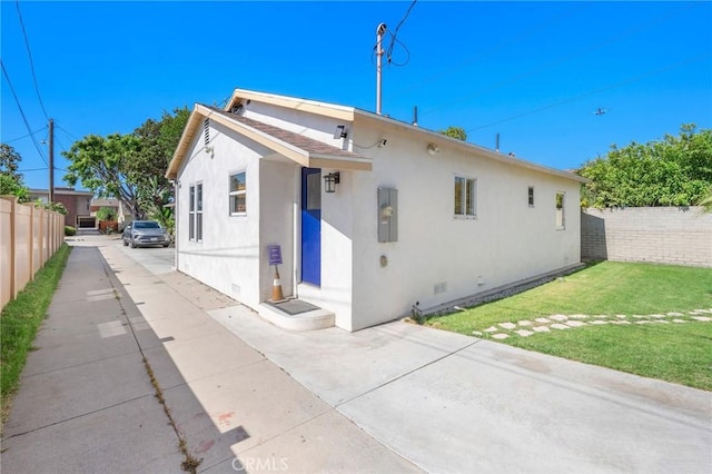 239 W Hillcrest Blvd, Inglewood, CA 90301 - back of house with stucco siding, concrete driveway, crawl space, and a patio area