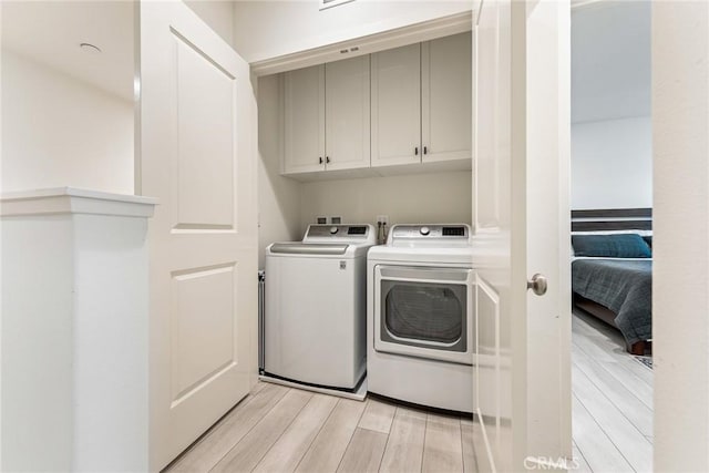 304 Floral Vw, Irvine, CA 92618 - washroom featuring cabinet space, washer and dryer, and light wood-style flooring
