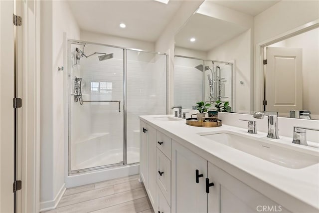 304 Floral Vw, Irvine, CA 92618 - bathroom with a shower stall, double vanity, recessed lighting, and wood finished floors