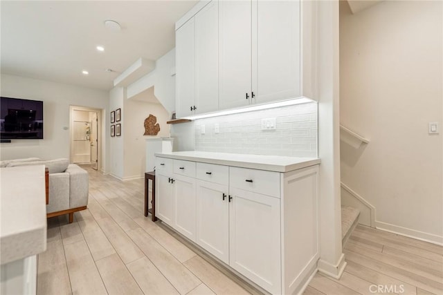 304 Floral Vw, Irvine, CA 92618 - kitchen featuring backsplash, white cabinetry, light wood-style floors, light countertops, and recessed lighting