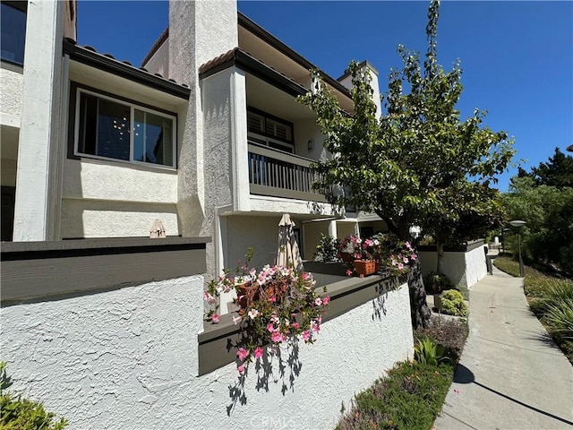 1688 Palisades Dr, Pacific Palisades, CA 90272 - view of side of property featuring stucco siding and a balcony