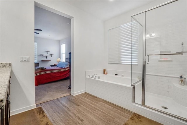 1246 Venice Ave, Mentone, CA 92359 - ensuite bathroom featuring wood finished floors, a bath, vanity, and a shower stall