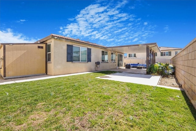 1246 Venice Ave, Mentone, CA 92359 - back of house featuring a patio area, stucco siding, and a fenced backyard