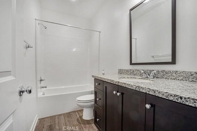 1246 Venice Ave, Mentone, CA 92359 - bathroom featuring wood finished floors, vanity, and washtub / shower combination