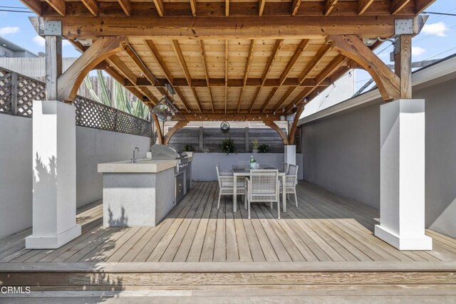 4961 Alcove Ave, Valley Village, CA 91607 - wooden deck with an outdoor kitchen and outdoor dining space