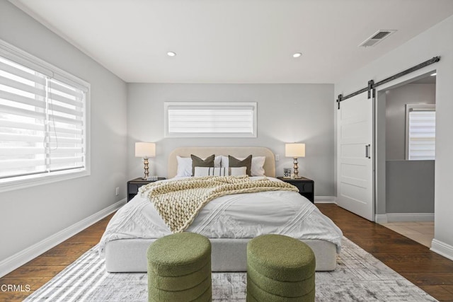 4961 Alcove Ave, Valley Village, CA 91607 - bedroom with a barn door, multiple windows, wood finished floors, and recessed lighting