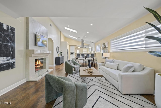 4961 Alcove Ave, Valley Village, CA 91607 - living room with vaulted ceiling, a high end fireplace, wood finished floors, and recessed lighting