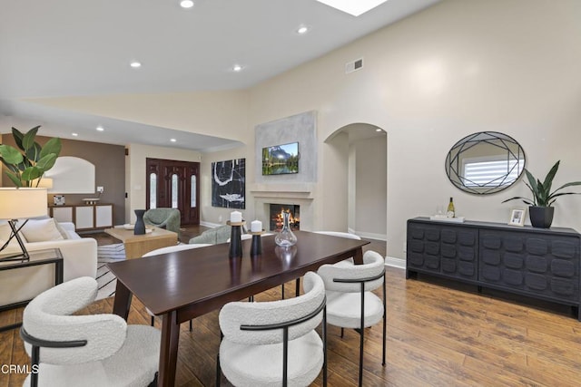 4961 Alcove Ave, Valley Village, CA 91607 - dining space featuring arched walkways, recessed lighting, wood finished floors, a high end fireplace, and high vaulted ceiling