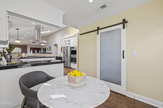 4961 Alcove Ave, Valley Village, CA 91607 - dining room with recessed lighting, dark wood-style floors, and a barn door