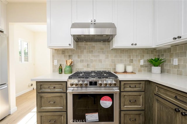 240 Rosemont Blvd, San Gabriel, CA 91775 - kitchen with stainless steel stove, extractor fan, light countertops, decorative backsplash, and light wood-style flooring