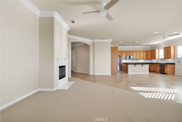 19570 Vermillion Ln, Apple Valley, CA 92308 - unfurnished living room with crown molding, recessed lighting, a ceiling fan, light colored carpet, and arched walkways