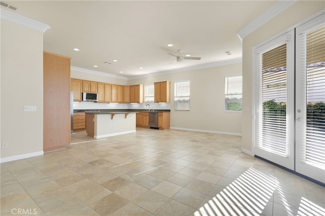 19570 Vermillion Ln, Apple Valley, CA 92308 - kitchen with stainless steel appliances, ornamental molding, a kitchen bar, a ceiling fan, and a center island