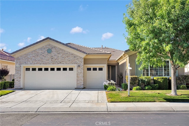 19570 Vermillion Ln, Apple Valley, CA 92308 - view of front facade with a garage, concrete driveway, a tile roof, a front yard, and stone siding
