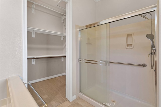 19570 Vermillion Ln, Apple Valley, CA 92308 - bathroom featuring a stall shower and a spacious closet