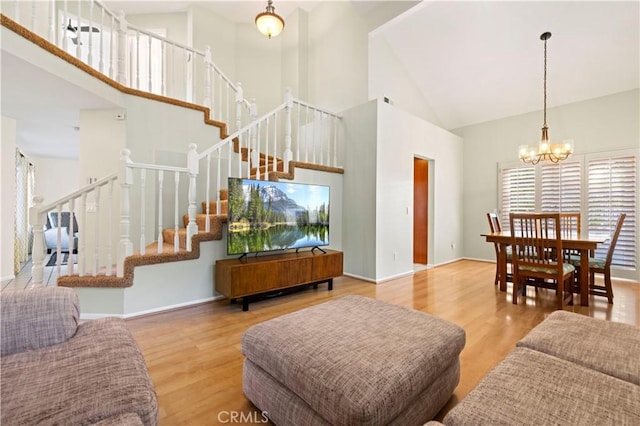 28610 Cloverleaf Pl, Castaic, CA 91384 - living room with high vaulted ceiling, a chandelier, stairs, and wood finished floors