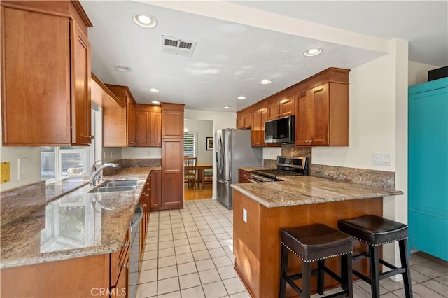 28610 Cloverleaf Pl, Castaic, CA 91384 - kitchen featuring stainless steel appliances, a peninsula, light tile patterned flooring, recessed lighting, and light stone counters