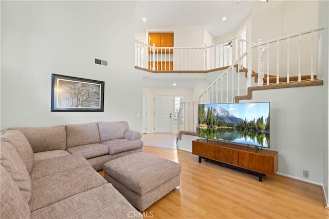 28610 Cloverleaf Pl, Castaic, CA 91384 - living area featuring a towering ceiling, wood finished floors, stairway, and recessed lighting