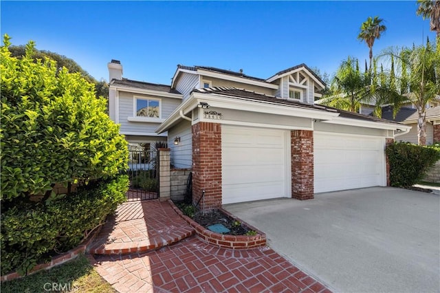 28610 Cloverleaf Pl, Castaic, CA 91384 - view of front facade featuring a chimney, driveway, and an attached garage